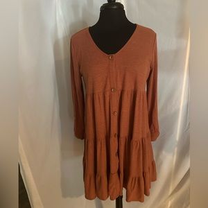 Ladies dress. It is rust in color. It is a size medium. Like new